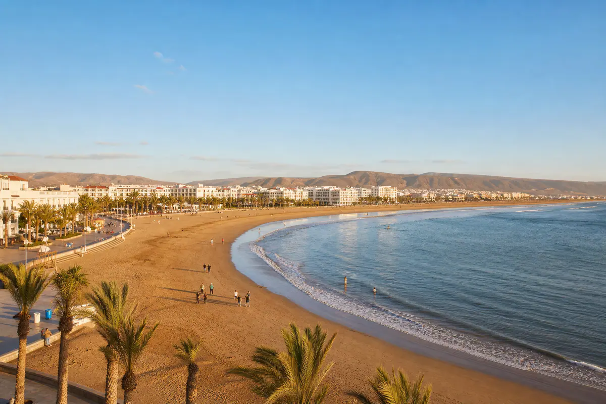 Wide sandy Agadir Beach curving beside the Atlantic Ocean and palm-lined seafront