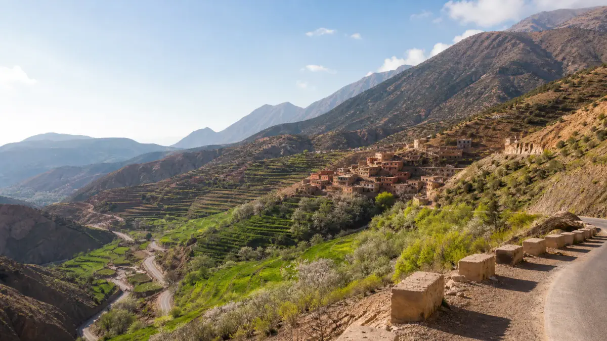 Terraced green valley, Amazigh village and rugged ridges in Morocco's High Atlas Mountains