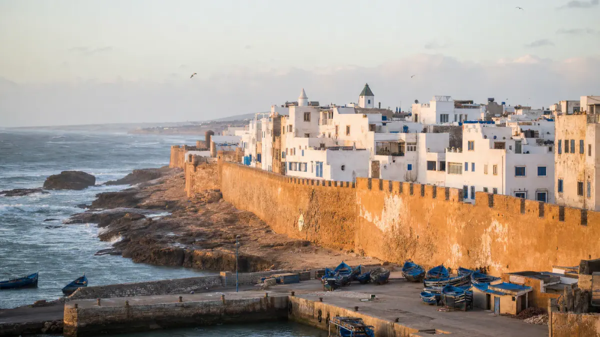 Essaouira medina, ochre ramparts and blue fishing boats beside the Atlantic