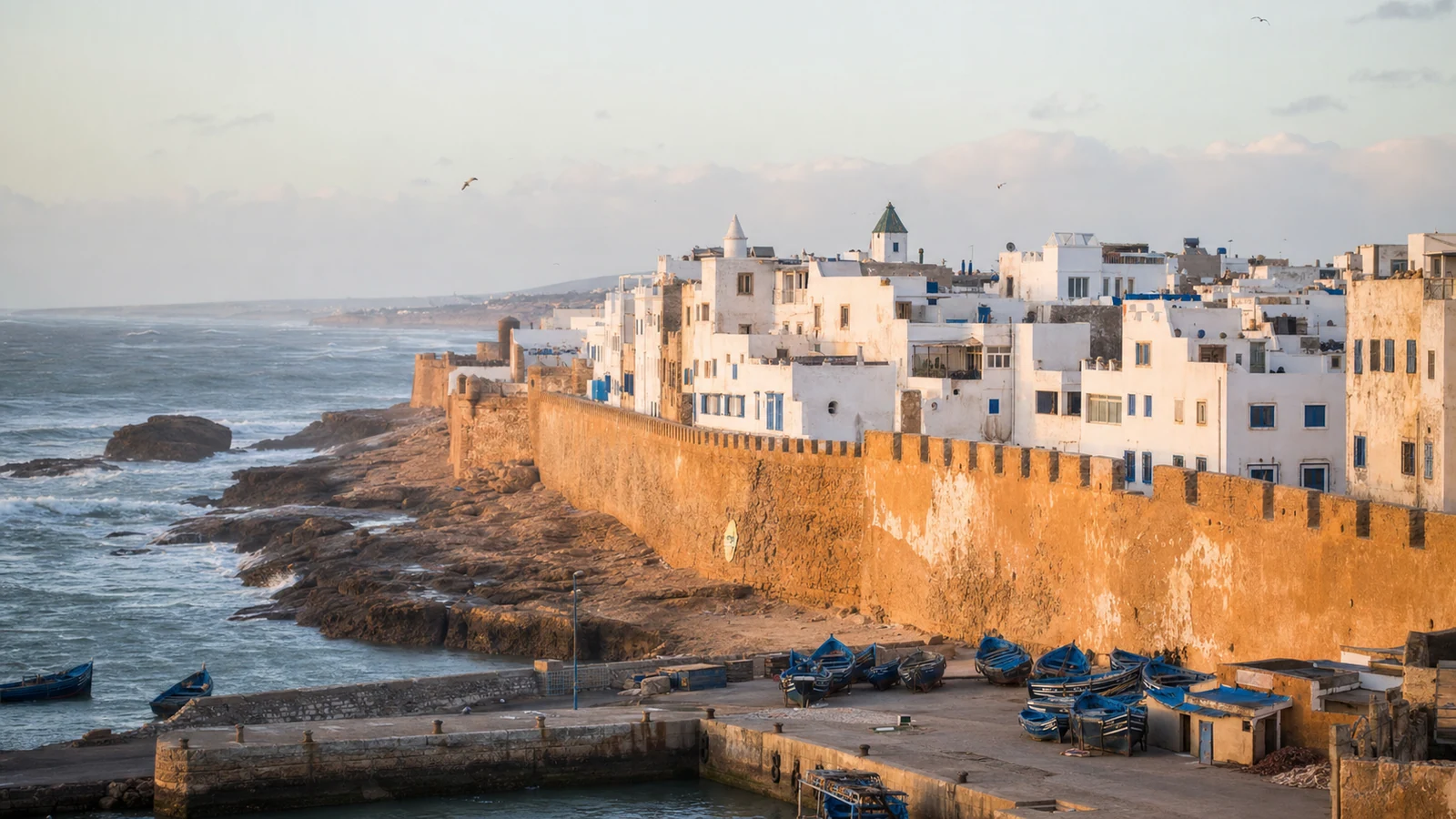 Essaouira medina, ochre ramparts and blue fishing boats beside the Atlantic