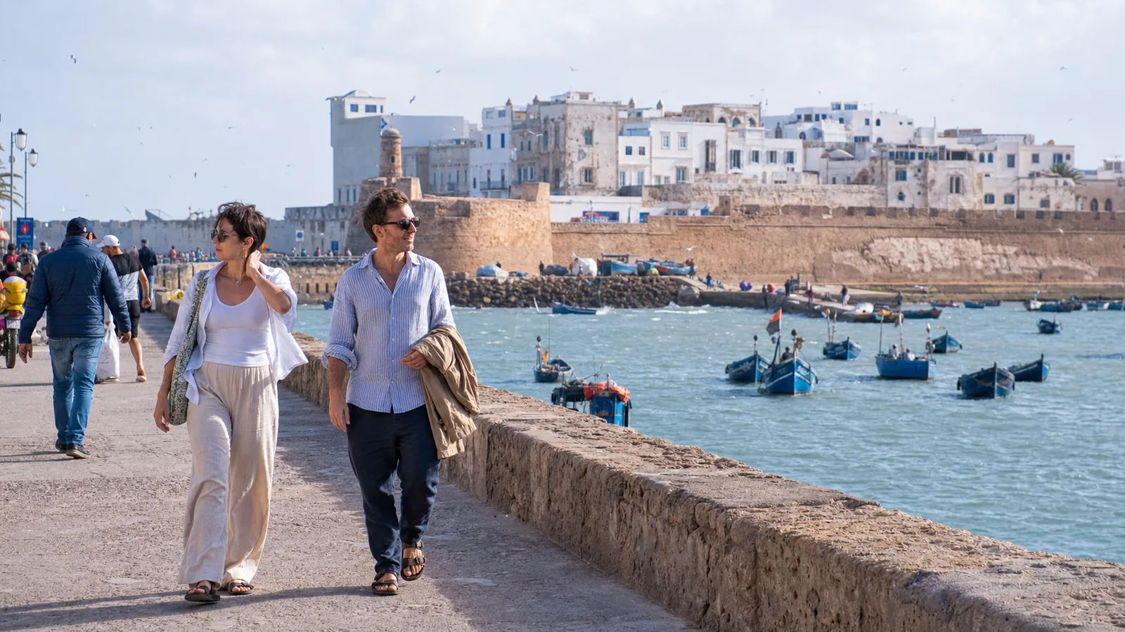 Travelers enjoying a breezy summer afternoon on Essaouira’s Atlantic waterfront