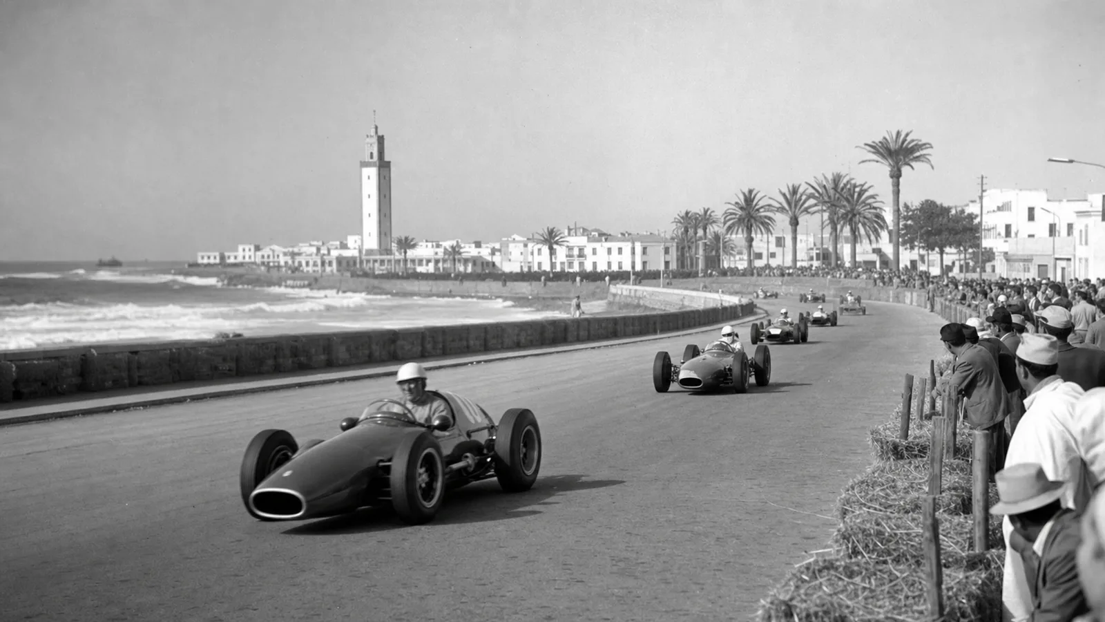 Historically inspired illustration of open-wheel cars racing on Casablanca’s coast in the late 1950s