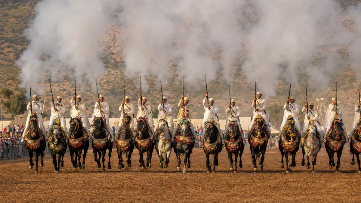 Moroccan Tbourida sorba charging in formation during a Fantasia performance
